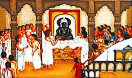 Devotees inside a grand hall offer prayers and rituals to a black idol on an ornate altar; priests and families gather in reverence.
